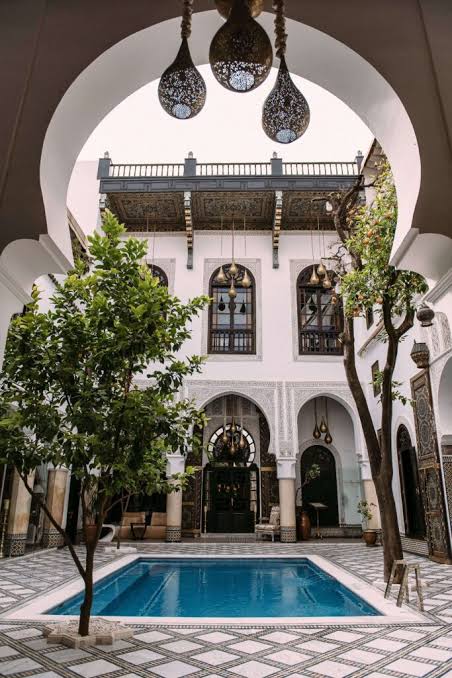 Interior of Fez Medina Hub — traditional carved plaster and zellij tilework